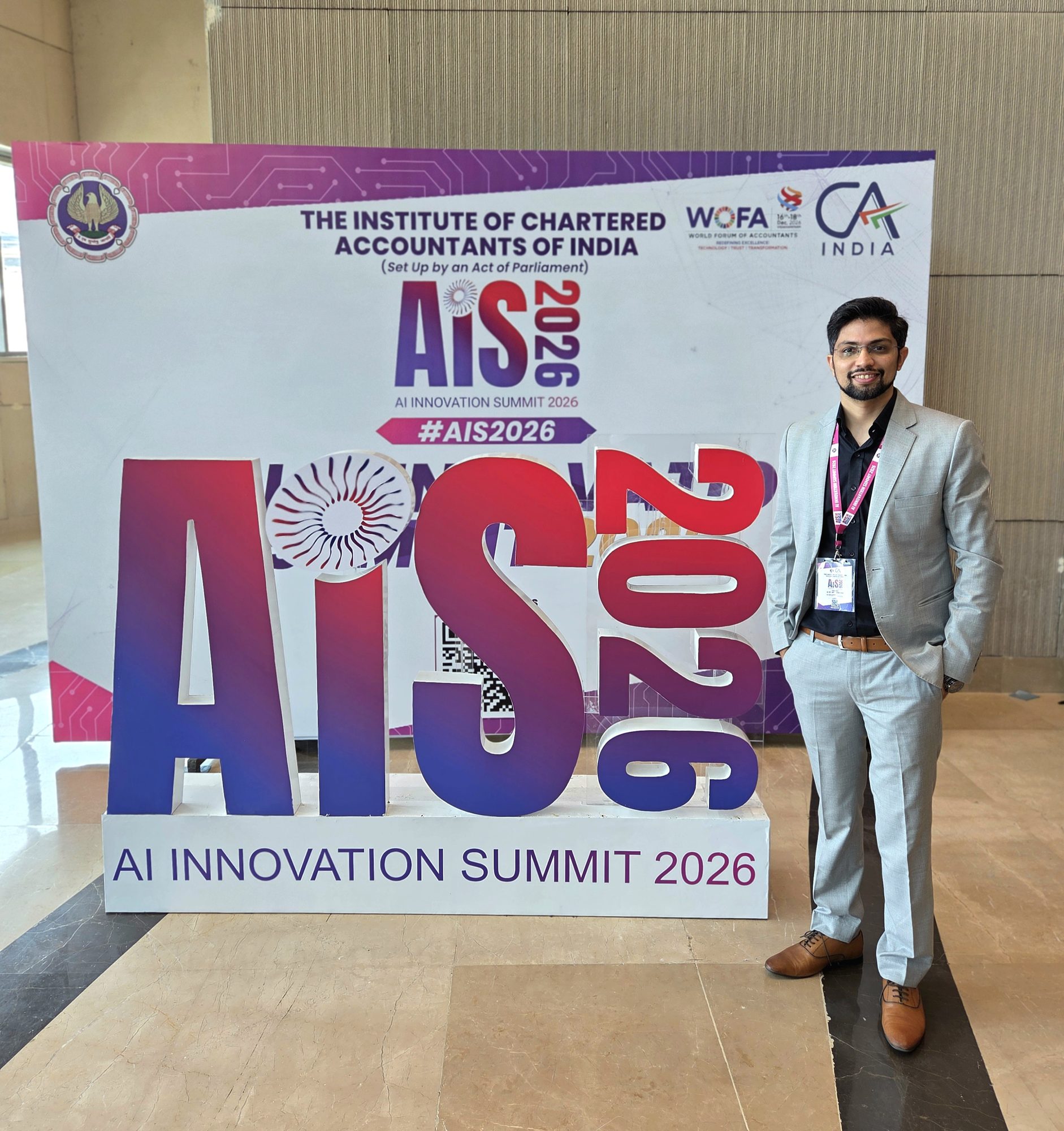 Rohan Sharma at ICAI's AI Innovation Summit 2026, standing beside the AiS 2026 backdrop at Bharat Mandapam, New Delhi.